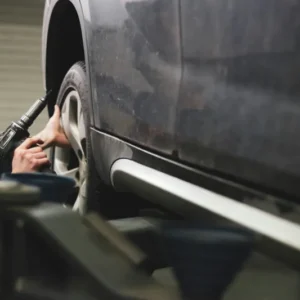 Pre-purchase vehicle inspection Oregon – technician under car