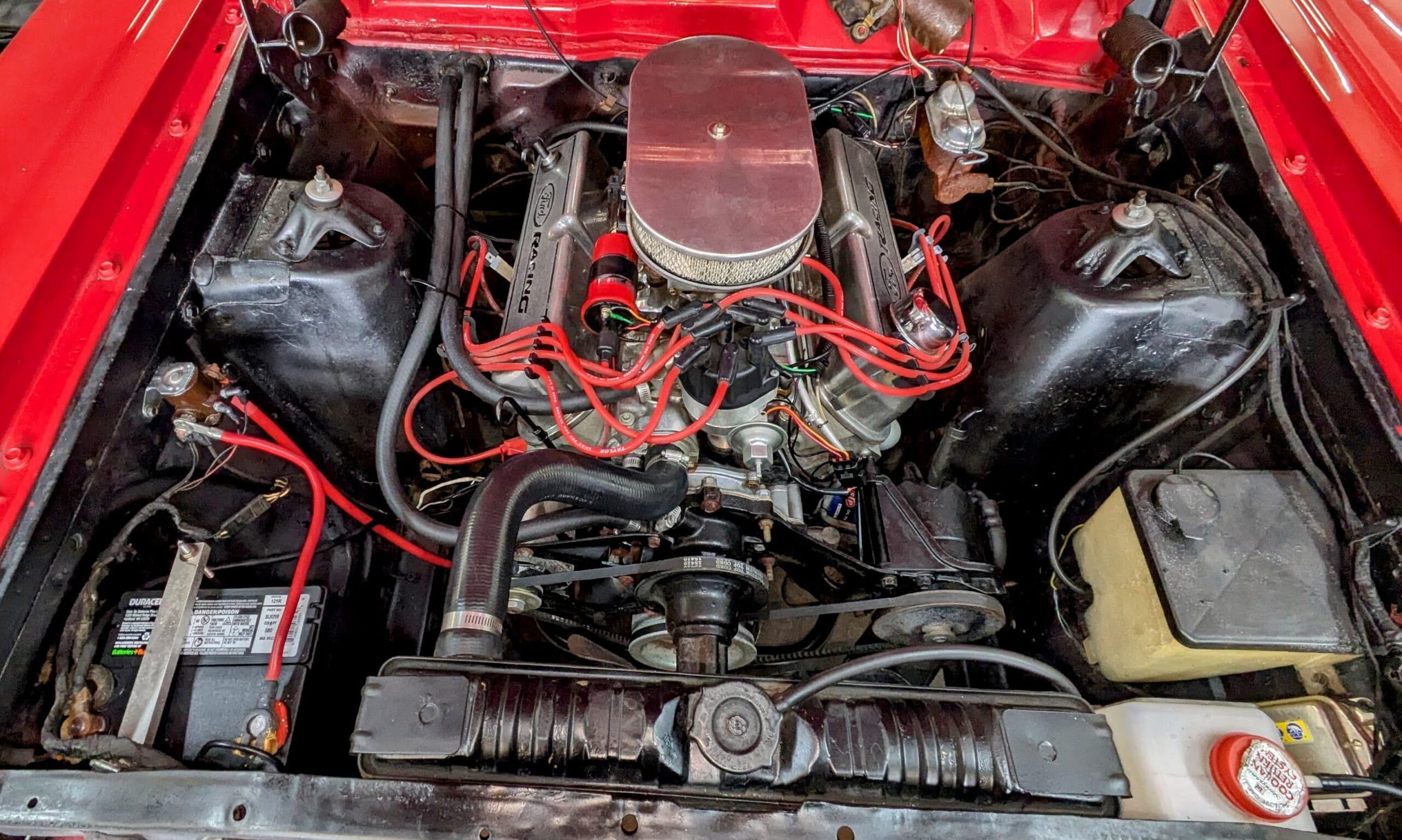 Classic car engine bay and fuel delivery inspection