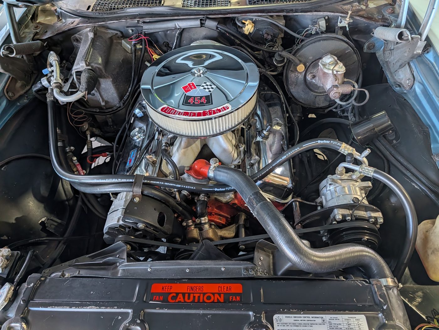 Big-block V8 engine bay of a classic Chevelle SS during a collector car inspection