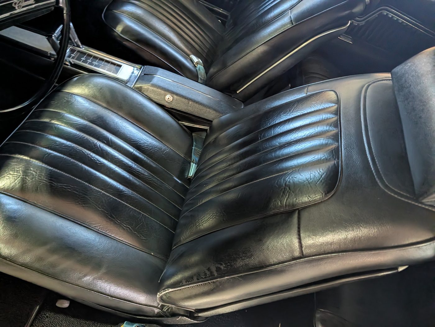 Black vinyl bench interior of a classic Chevelle SS, checked for originality and wear
