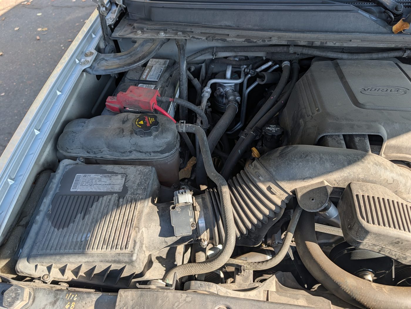 Full-size truck engine bay inspected for leaks, belts, and fluid condition