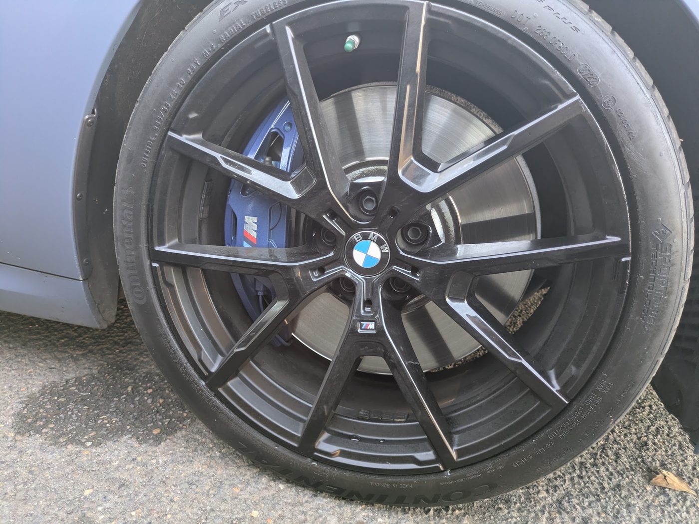 M Sport brake caliper, rotor, and wheel checked during a BMW M850i inspection
