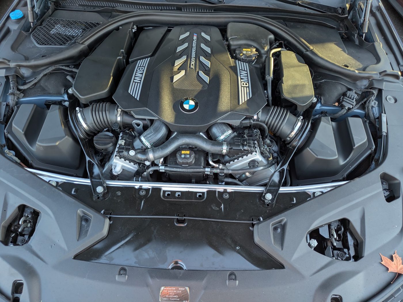 Twin-turbo V8 engine bay of a BMW M850i, inspected for leaks and service condition