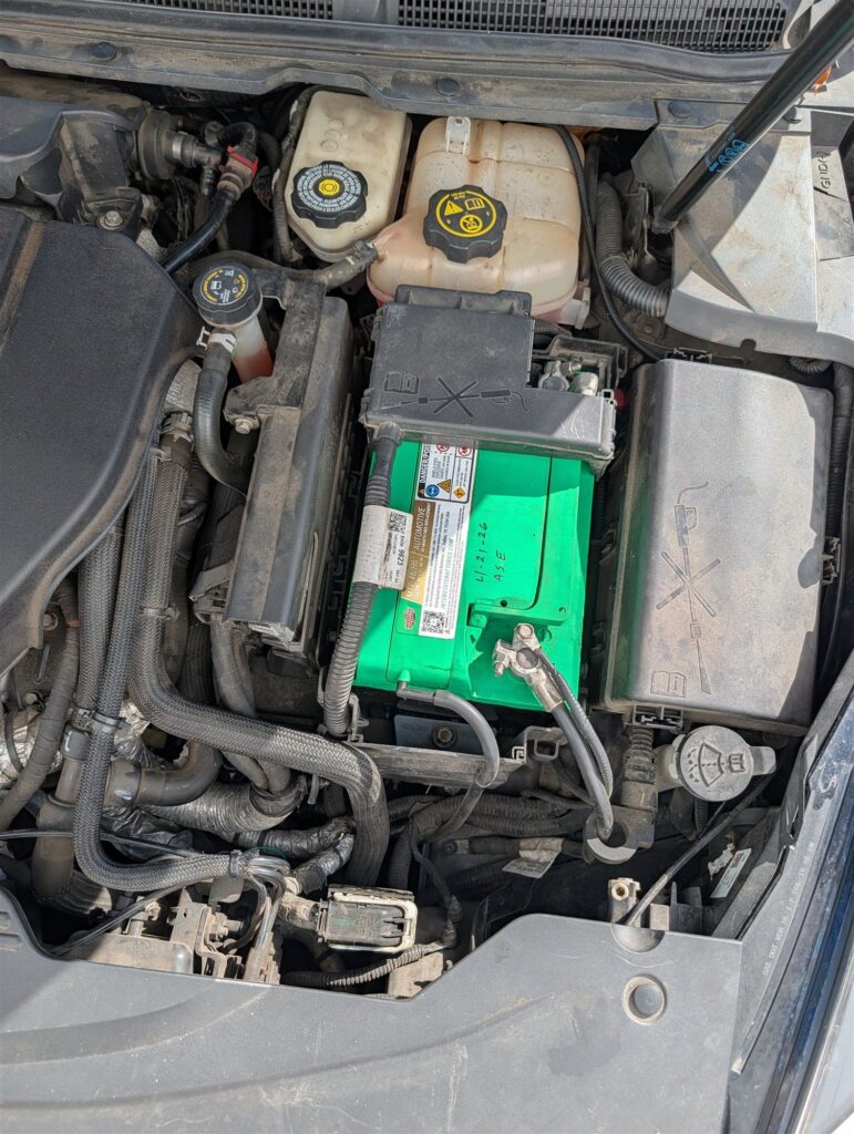 Engine bay, battery, and fluid reservoirs checked during a pre-purchase inspection in Corvallis, Oregon
