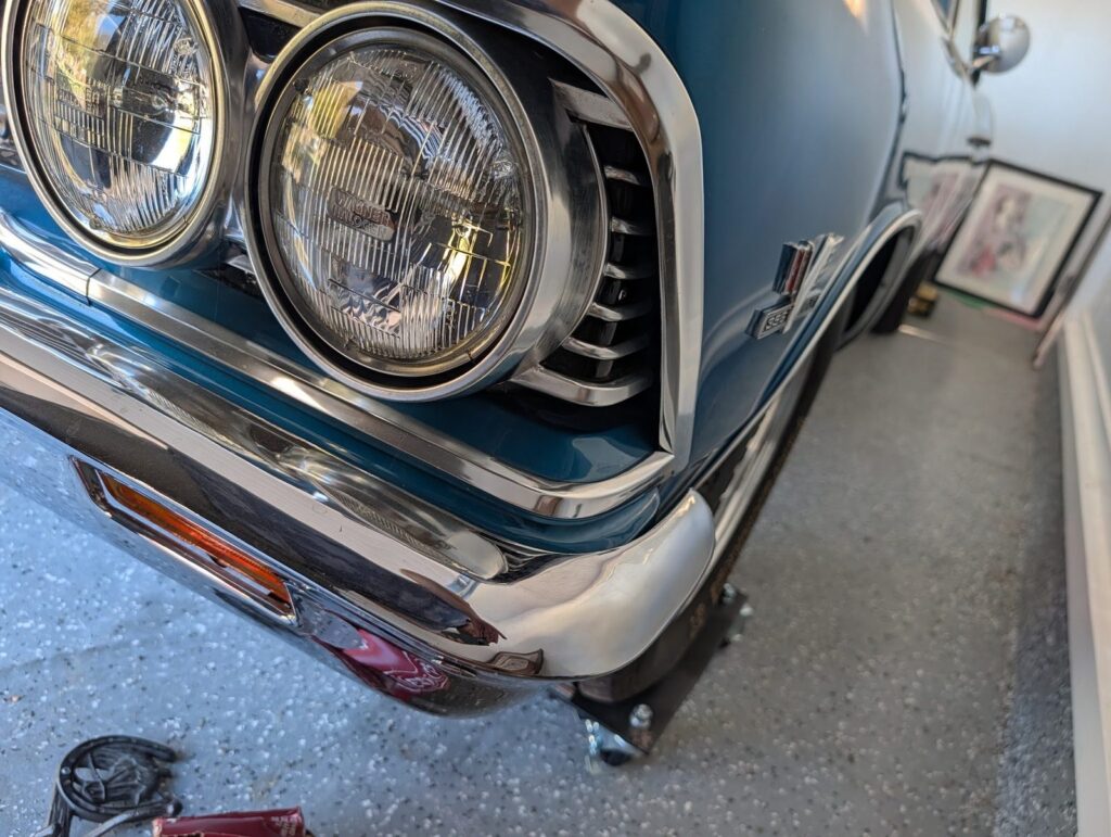 Dual headlights and chrome grille detail checked during a classic car inspection in Corvallis, Oregon