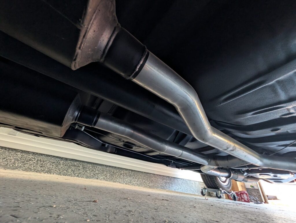 Undercarriage, exhaust, and floor pans inspected from below during a Cottage Grove vehicle inspection