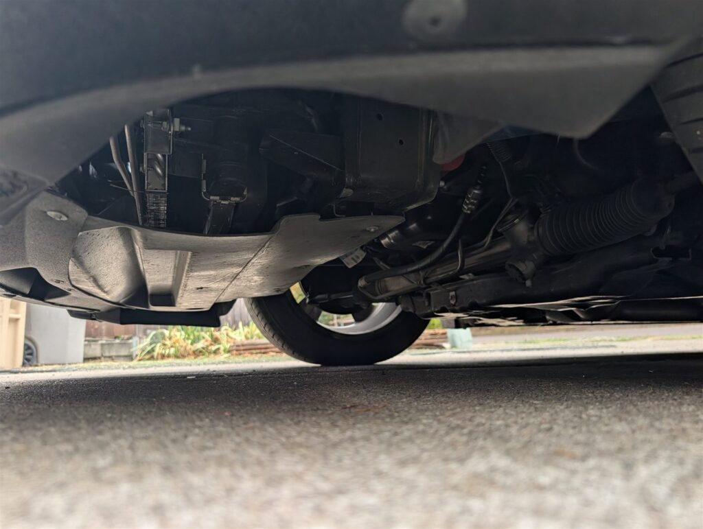 Underbody and front suspension inspected from below during a Medford car inspection