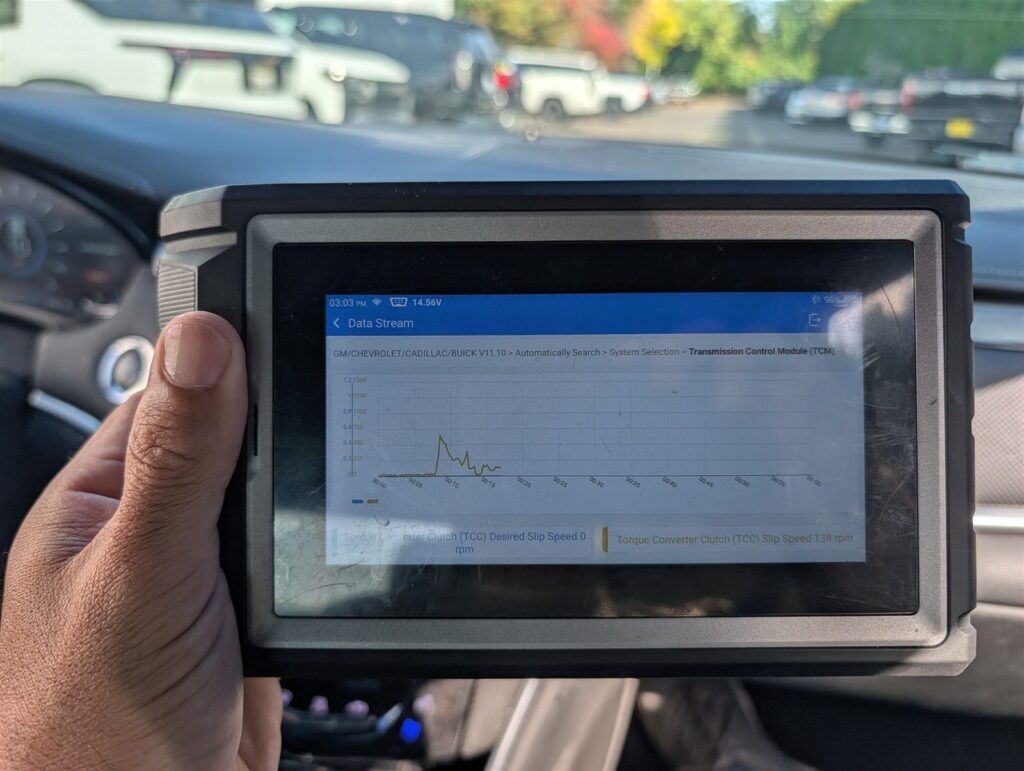 Inspector reviewing live transmission data on a diagnostic scan tool during a vehicle inspection