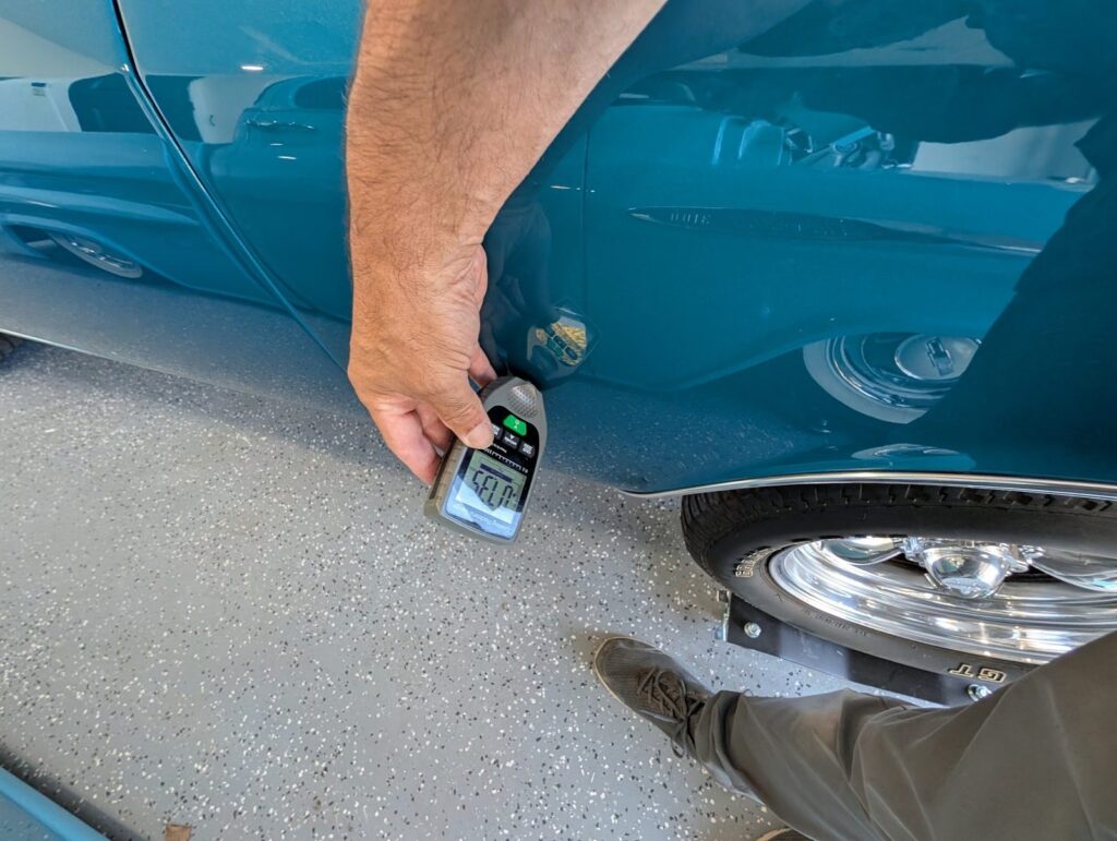 Paint thickness gauge measuring a fender to check for hidden bodywork during an inspection